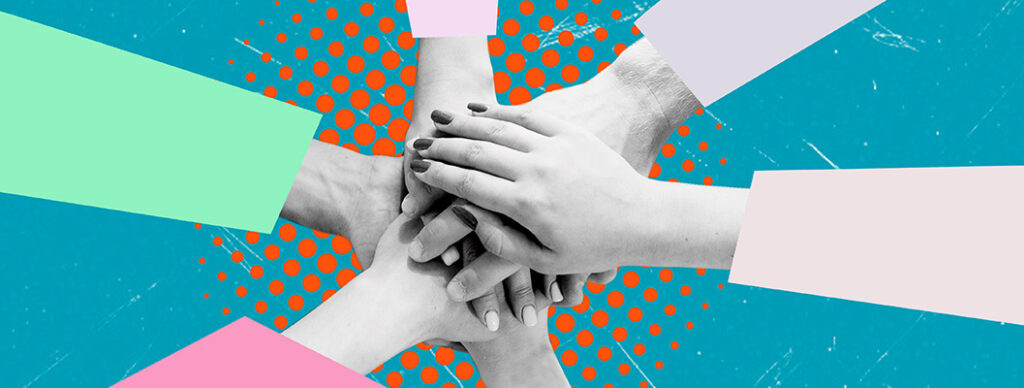 A view from above of people putting their hands together in a huddle